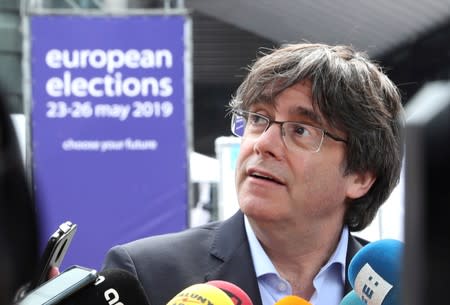 FILE PHOTO: Former Catalan President Carles Puigdemont talks to the media during European Parliament elections outside the EU Parliament in Brussels