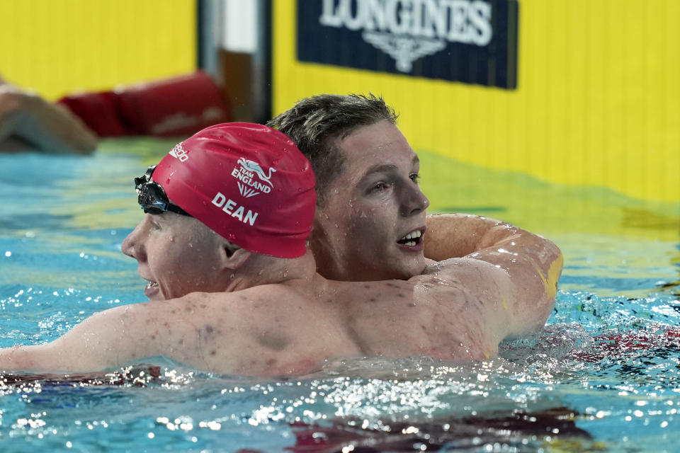 Duncan Scott of Scotland is congratulated by Tom Dean of England, left, after winning the gold medal in the Men's 200 meters freestyle final during the Commonwealth Games at the Sandwell Aquatics Centre in Birmingham, England, Saturday, July 30, 2022. (AP Photo/Aijaz Rahi)