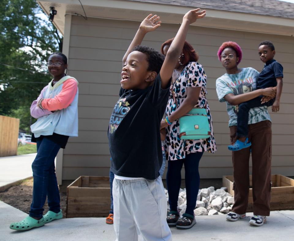 Josiah Avery, 5, raises his hands as his parents Austin Avery, president and CEO of The Original Project Team, and Laresia Avery speak at a celebration for the new Fish-n-loaves sustainability hub Friday, July 1, 2022, at 2854 Douglass Avenue in Orange Mound. The location will feature food distribution, garden and a place to educate on home gardening.