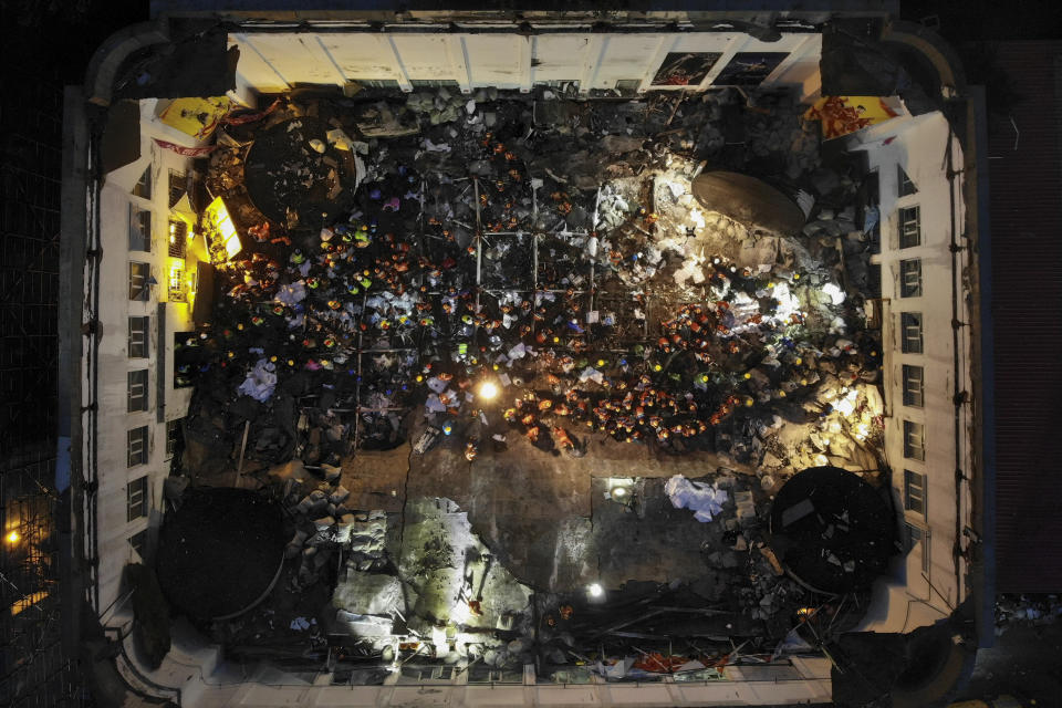 In this photo released by Xinhua News Agency, an aerial view shows rescuers conducting search and rescue operation at the site of a roof collapsed middle school gymnasium in Qiqihar, in northeast China's Heilongjiang Province on Monday, July 24, 2023. More than 10 people were killed when a roof collapsed at a middle school gymnasium in China's far northeast, authorities said Monday. (Wang Song/Xinhua via AP)