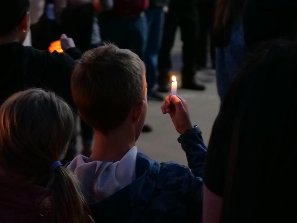 A boy takes part in a Monday, May 15 candlelight vigil at The Hills Church held to honor the victims of Monday's shooting in a Farmington residential neighborhood.