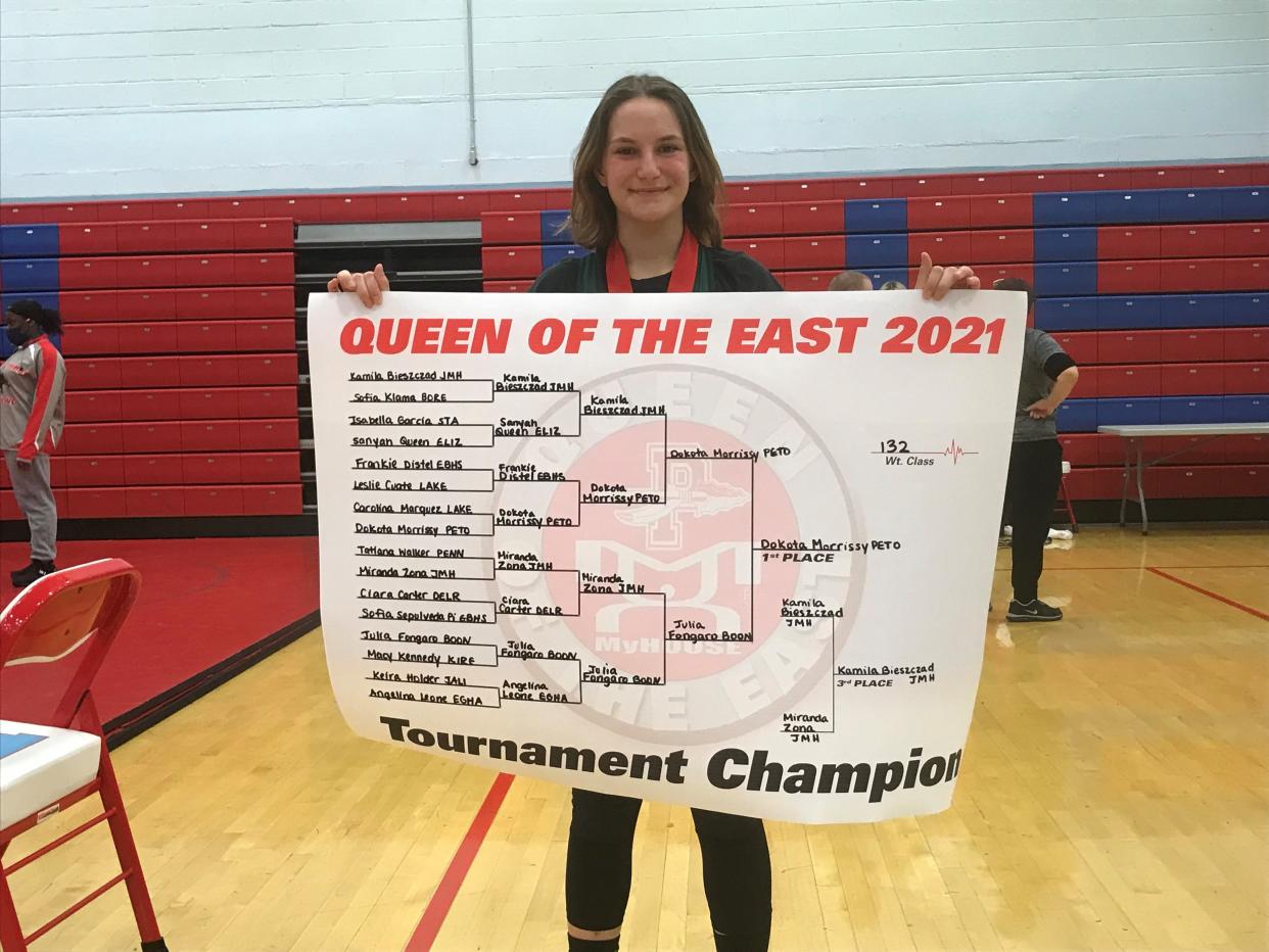 Pemberton's Dakota Morrissey displays her the winning bracket after she won the 132-pound title at the Queen of the East Tournament on Saturday.