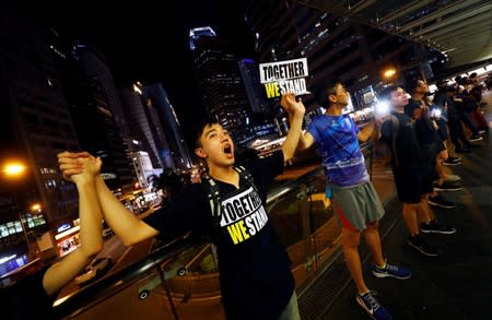 Protesters hold hands to form a human chain during a rally to call for political reforms in Hong Kong's Central district