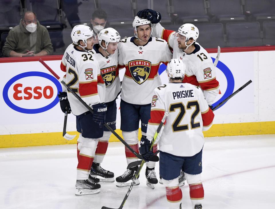 Florida Panthers' Mason Marchment (17) celebrates his goal against the Winnipeg Jets with Lucas Carlsson (32), Anton Lundell (15), Sam Reinhart (13) and Chase Priskie (22) during the first period of an NHL hockey game, Tuesday, Jan. 25, 2022 in Winnipeg, Manitoba. (Fred Greenslade/The Canadian Press via AP)