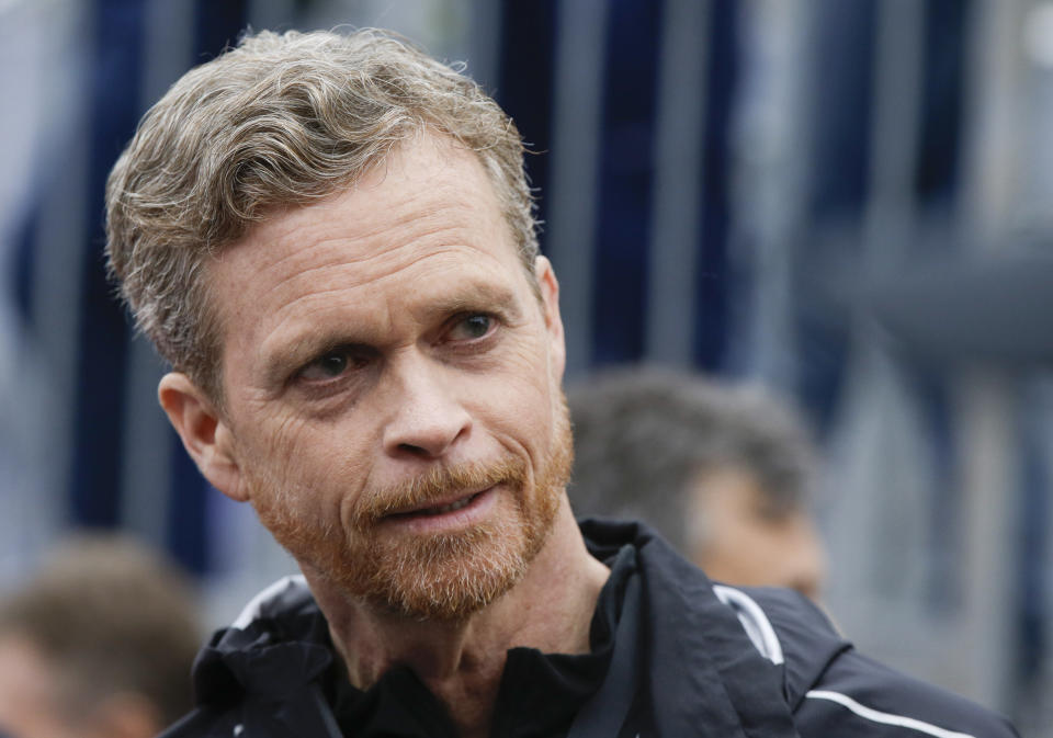 FILE - In this May 6, 2017, file photo Nike CEO and President Mark Parker talks at the finish line of a 2 hours marathon, at the Monza Formula One racetrack, Italy. Parker is stepping down early next year. He will be replaced by board member John Donahoe, who formerly ran e-commerce company eBay. (AP Photo/Luca Bruno, File)