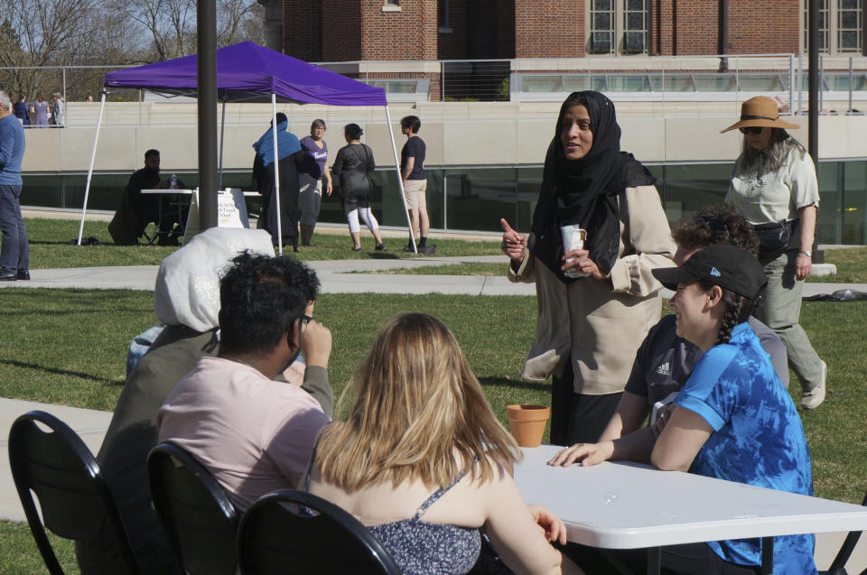 Sadaf Shier (standing), the Muslim chaplain at the University of St. Thomas, talks with students attending the school's celebration for the end of the Muslim holy month of Ramadan in St. Paul, Minn., on Saturday, May 7, 2022. She helped organize the event, which included several stress-reducing activities, as part of a broadening of the mission of campus ministry to address holistic student wellbeing. (AP Photo/Giovanna Dell'Orto)