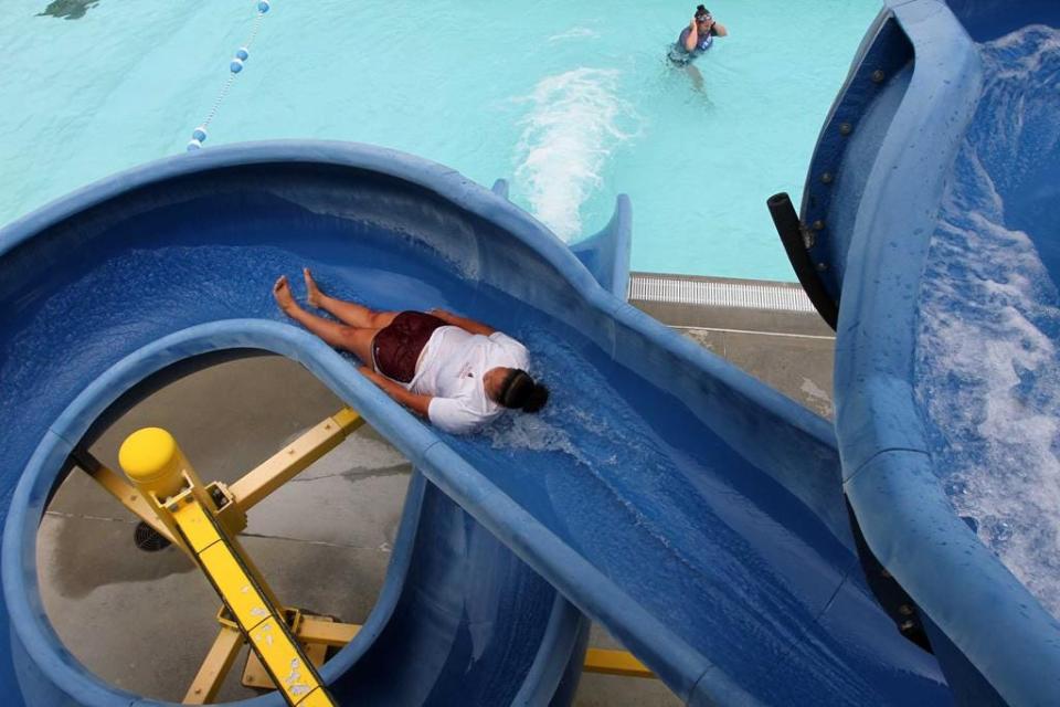 The New Bern Aquatic Center welcomes swimmers as the facility opens to the public for the 2020 summer season. Lifeguard Kennedy Nesmith slides to a splash before opening hours at the public pool that features interactive water falls, slides, swim lanes, zero-entry pool depths and a concession stand. The New Bern Aquatic Center, operated by New Bern Parks and Recreation, is located at 1155 Laura Lane in New Bern, NC.