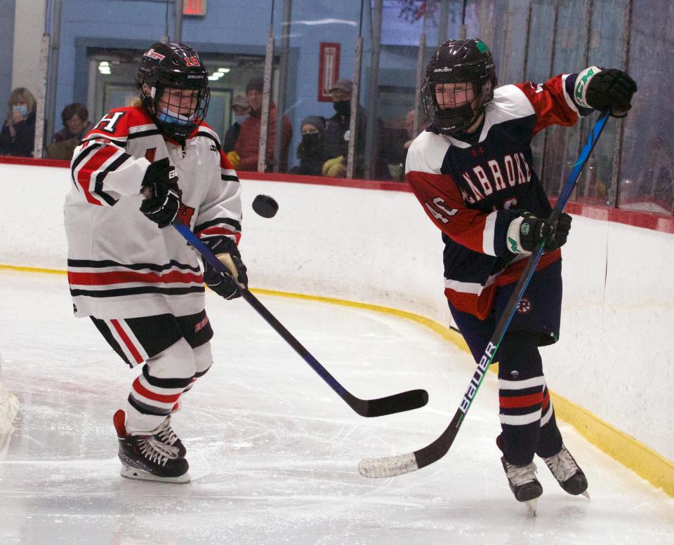 Pembroke's Jen Birolini (right) fights for the puck with Hingham's CC Flynn (left) during a game at Pilgrim Skating Arena in Hingham on Saturday, January 15, 2022.