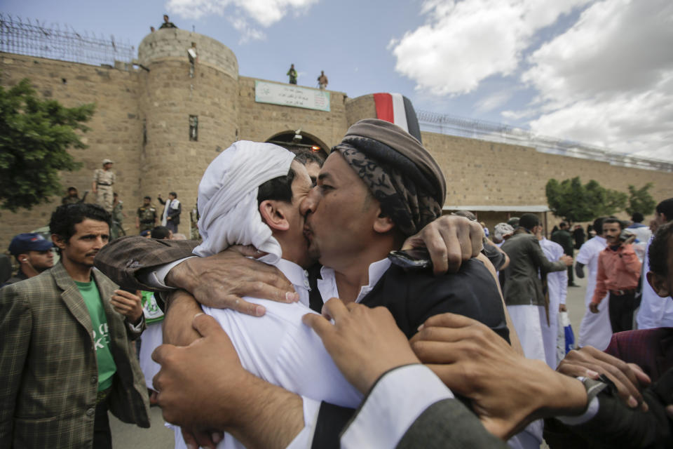A Yemeni detainee is greeted by his relative after his release from a prison controlled by Houthi rebels, in Sanaa, Yemen, Monday, Sept. 30, 2019. The International Committee of the Red Cross says Yemen's Houthi rebels have released 290 detainees rounded up over the years and held in several detention centers across the war-torn country. (AP Photo/Hani Mohammed)