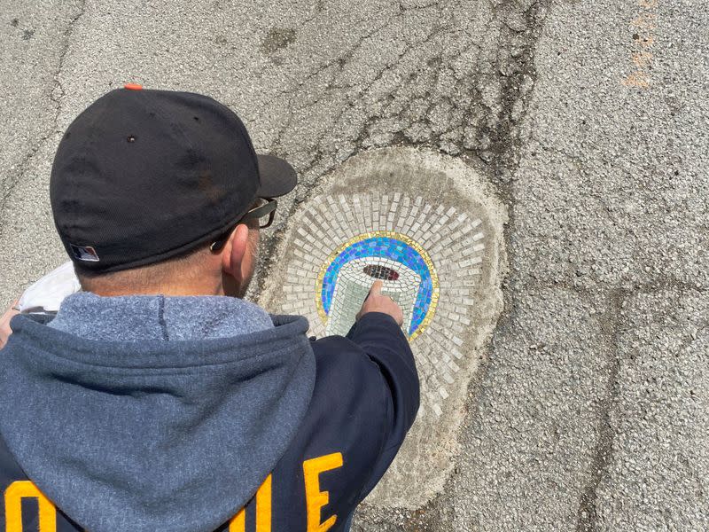 Chicago artist Jim Bachor creates four pandemic-themed pothole mosaics on the city's North Side