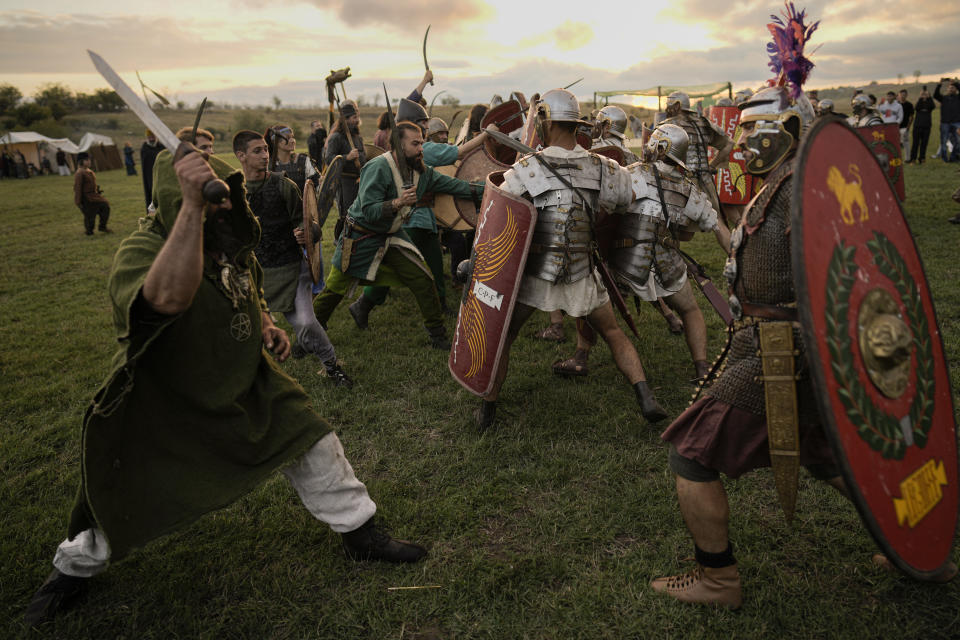 Participants in the Romula Fest historic reenactment event clash during a battle in the village of Resca, Romania, Saturday, Sept. 3, 2022. (AP Photo/Vadim Ghirda)