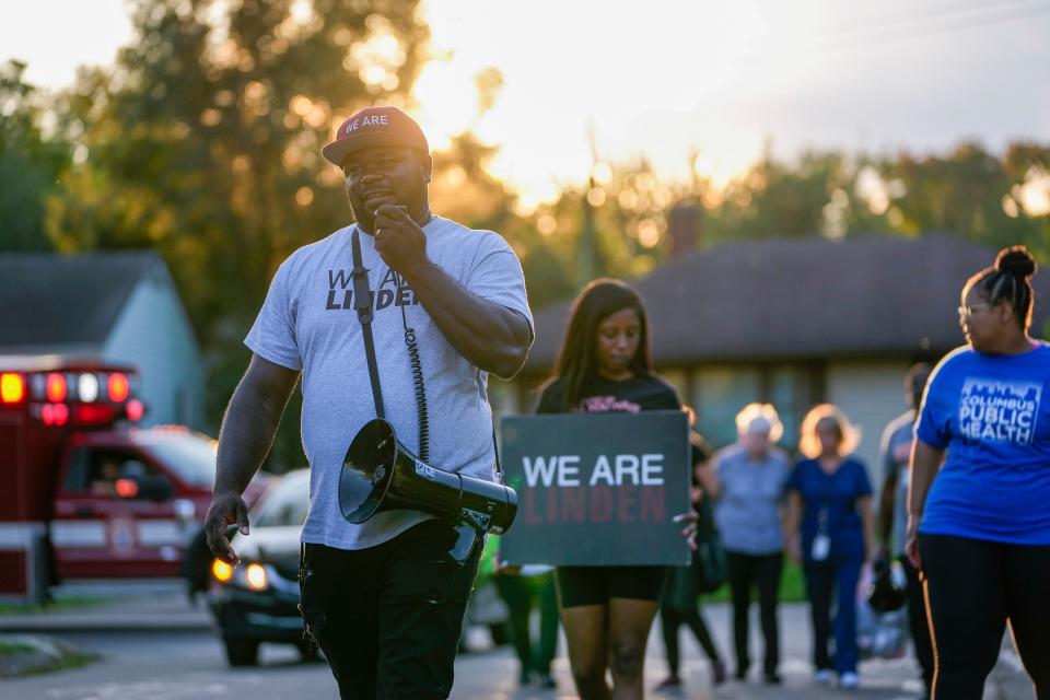 Ralph Carter, founder of We Are Linden, speaks into a megaphone during a recent anti-gun violence walk through a Linden neighborhood.