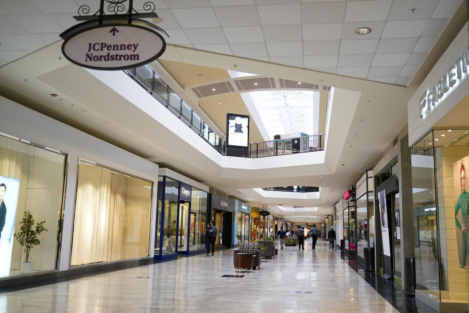 In this photo made on Wednesday, Feb. 24, 2021, people walks through a shopping mall in Pittsburgh. The pandemic emptied malls and restaurants and accelerated a trend toward online ordering and delivery. It’s not yet clear if shoppers and diners will ever return to their old habits. (AP Photo/Keith Srakocic)