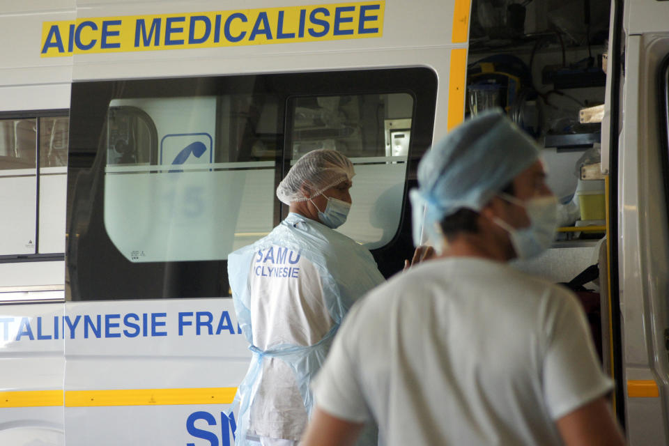 Medical workers stand at the emergency service of the hospital in Papeete, Tahiti island, French Polynesia, Friday Aug. 20, 2021. France's worst virus outbreak so far is unfolding 12 times zones away from Paris, devastating Tahiti and the idyllic atolls of French Polynesia. It's France's latest challenge in juggling resources to battle the pandemic in former colonies that stretch around the world (AP Photo/Esther Cuneo)