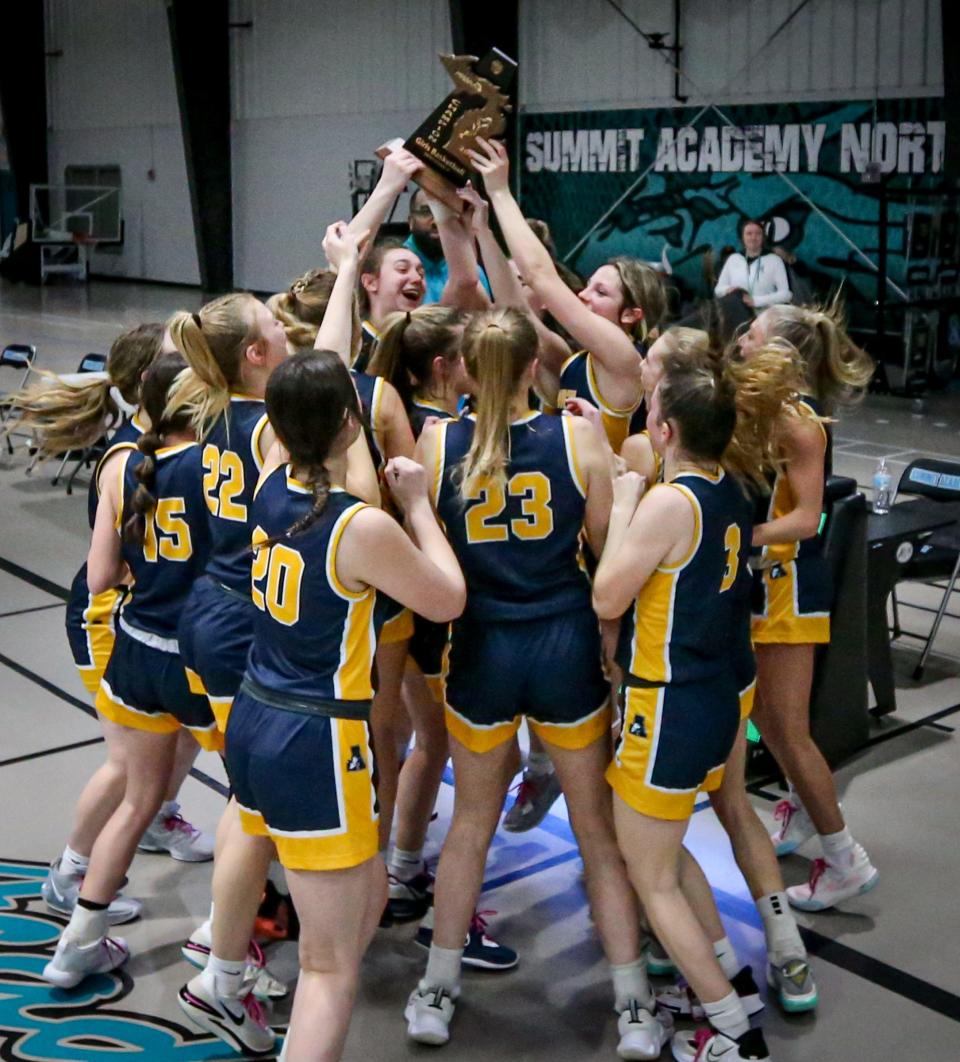 Airport's girls basketball team celebrates after a 64-46 victory over Grosse Ile in the finals of the Division 2 District at Summit Academy on Friday, March 8, 2024.