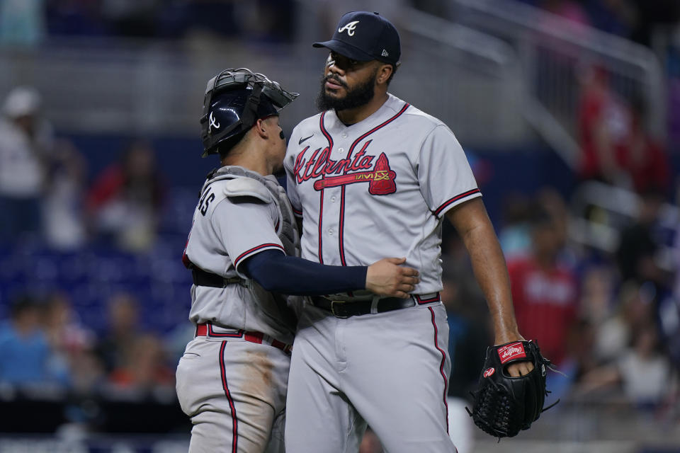 Atlanta Braves relief pitcher Kenley Jansen, right, and catcher William Contreras congratulate each other after the Braves beat the Miami Marlins 4-3 in a baseball game, Friday, Aug. 12, 2022, in Miami. (AP Photo/Wilfredo Lee)