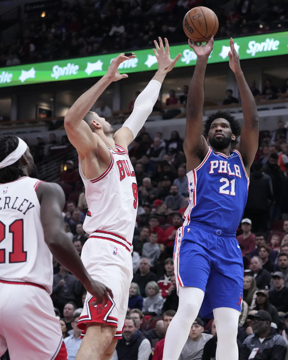 Philadelphia 76ers' Joel Embiid shoots over Chicago Bulls' Nikola Vucevic during the first half of an NBA basketball game Wednesday, March 22, 2023, in Chicago. (AP Photo/Charles Rex Arbogast)