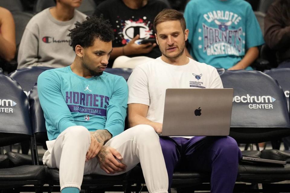 Charlotte Hornets guard James Bouknight (2) talks with a coach during pregame warm ups against the Toronto Raptors at Spectrum Center. USA TODAY Sports