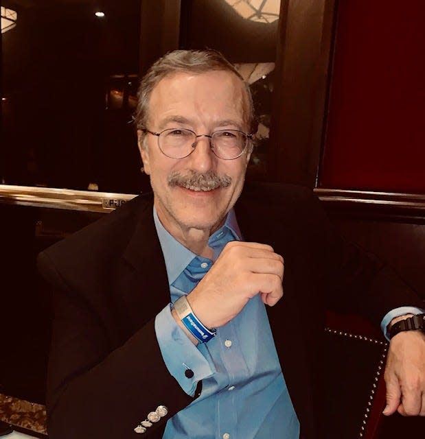 Dr. Tashof Bernton shows off his ImmunaBand, a $20 wristband he created that features a QR code link to the wearer's official vaccination records.