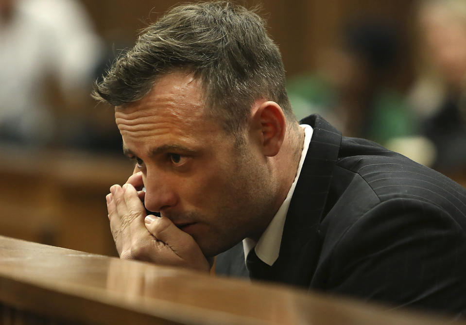 FILE - Oscar Pistorius speaks on a mobile phone in the High Court in Pretoria, South Africa, June 15, 2016 during his sentencing hearing for murdering girlfriend Reeva Steenkamp. Pistorius has applied for parole and is expected to attend a hearing on Friday, March 31, 2023 that will decide if the former Olympic runner is released from prison 10 years after killing girlfriend Reeva Steenkamp. (Alon Skuy/Pool Photo via AP, File)