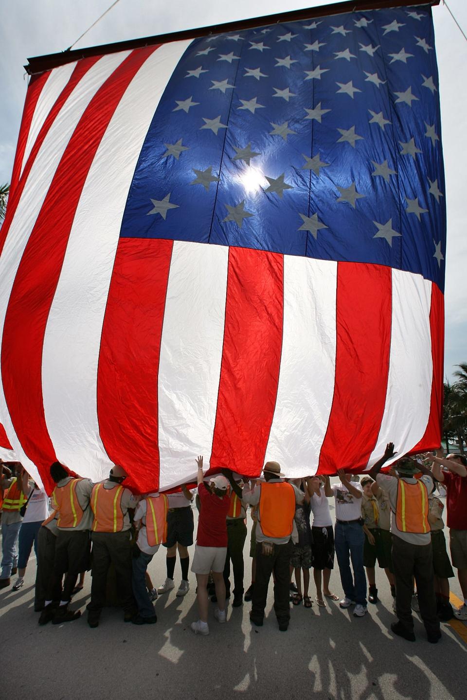 The Delray Beach 4th of July Celebration on East Atlantic Avenue begins with the raising of a 60-foot flag and singing of the National Anthem.