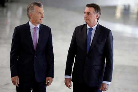 Argentina's President Mauricio Macri is welcomed by Brazil's President Jair Bolsonaro during a meeting in Brasilia, Brazil January 16, 2019. REUTERS/Ueslei Marcelino