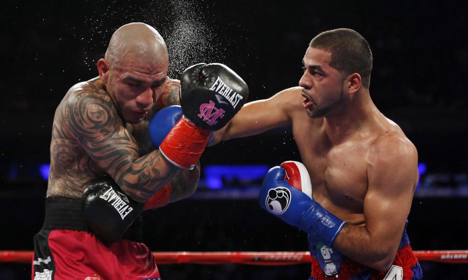 Sadam Ali, right, lands a punch on Miguel Cotto during the fifth round of their WBO junior middleweight title fight on Saturday in New York.