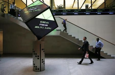 People walk through the lobby of the London Stock Exchange in London, Britain August 25, 2015. REUTERS/Suzanne Plunkett/File photo