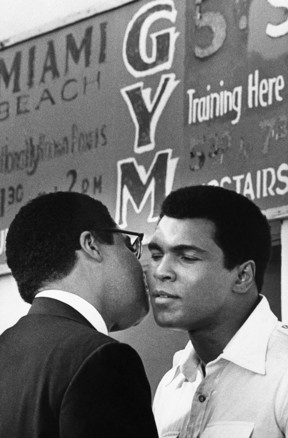 1976: Muhammad Ali does a cheek to cheek goodbye to actor James Earl Jones in a scene in which Jones portrays Malcome X in the movie 