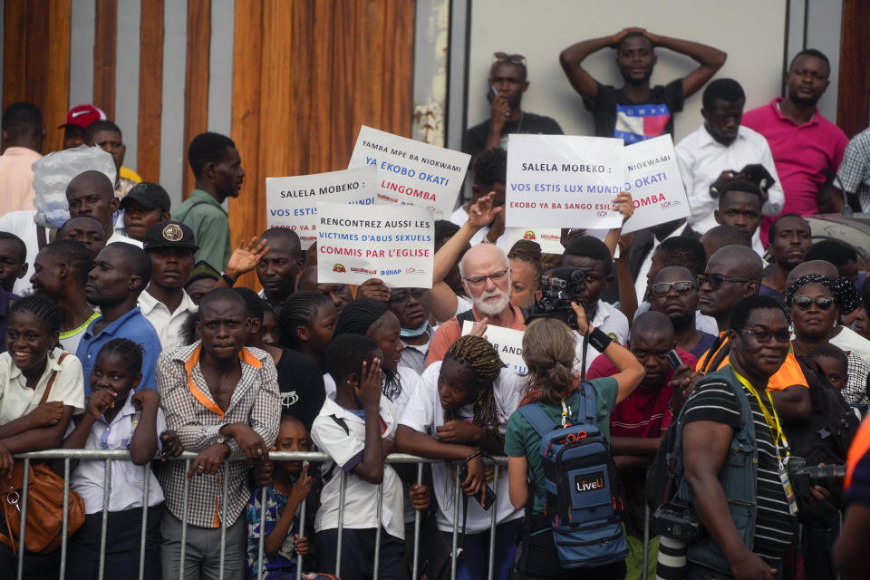 Members of clerical sexual abuse survivors organisations hold banners outside the "Notre Dame du Congo" cathedral in Kinshasa prior to the arrival of Pope Francis for a meeting with priests, deacons, consecrated people and seminarians, Democratic Republic of Congo, Thursday, Feb. 2, 2023. Francis is in Congo and South Sudan for a six-day trip, hoping to bring comfort and encouragement to two countries that have been riven by poverty, conflicts and what he calls a "colonialist mentality" that has exploited Africa for centuries. (AP Photo/Gregorio Borgia)