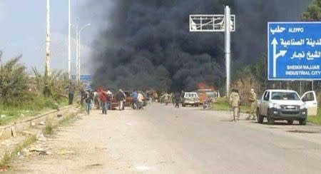 Still image shows a cloud of black smoke rising from vehicles in the distance in what is said to be Aleppo's outskirts, Syria April 15, 2017. Social Media Website via Reuters TV