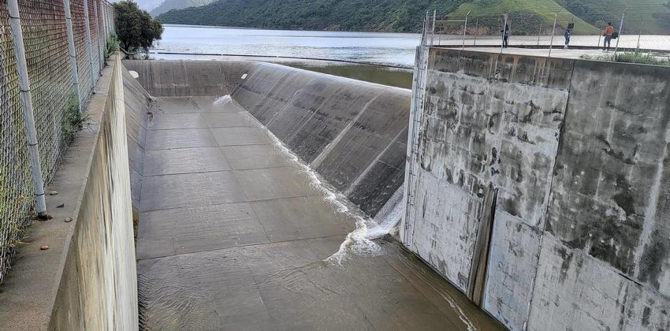 Lake Lopez finally naturally spills over the chute at in the early morning, Thursday, Mar. 23, 2023.