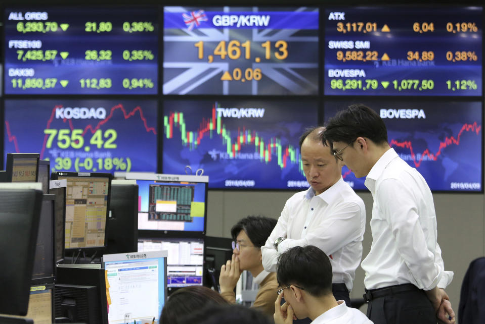 Currency traders work at the foreign exchange dealing room of the KEB Hana Bank headquarters in Seoul, South Korea, Wednesday, April 10, 2019. Asian shares fell Wednesday following a slide on Wall Street amid growing tensions between the U.S. and the European Union and a dim forecast on global economic growth.(AP Photo/Ahn Young-joon)