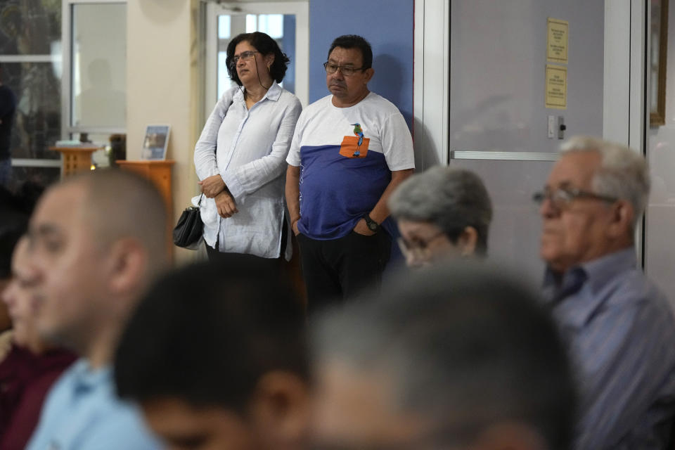 Donal Alvarenga, center, listens along with other parishioners during Mass at St. Agatha Catholic Church, which has become the spiritual home of the growing Nicaraguan diaspora, Sunday, Nov. 5, 2023, in Miami. Alvarenga rarely attended Mass in Nicaragua but doesn't miss one here since he was among more than 200 Nicaraguans released from detention, forcibly expelled to the United States in February and later stripped of citizenship by the regime of President Daniel Ortega. (AP Photo/Rebecca Blackwell)