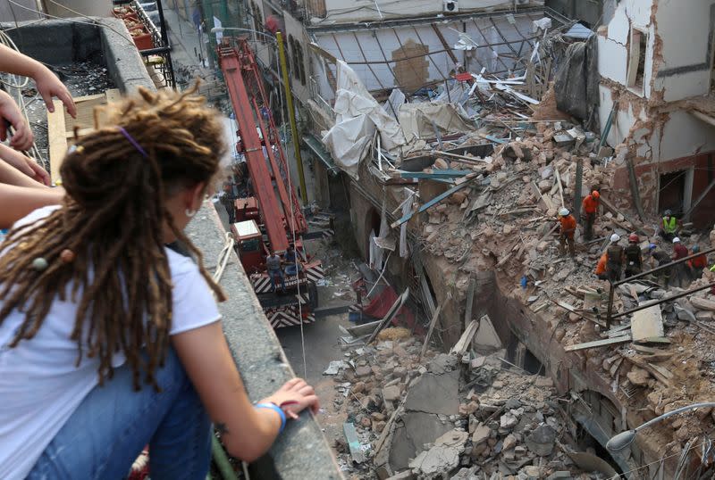 Rescue team members search through buildings damaged due to the massive explosion at Beirut's port area in Gemmayze