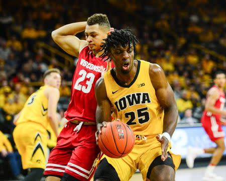 Nov 30, 2018; Iowa City, IA, USA; Iowa Hawkeyes forward Tyler Cook (25) secures a rebound in front of Wisconsin Badgers guard Kobe King (23) during the first half at Carver-Hawkeye Arena. Jeffrey Becker-USA TODAY Sports - 11761627
