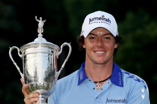 Rory McIlroy of Northern Ireland poses with the trophy after his eight-stroke victory on the 18th green during the 111th U.S. Open at Congressional Country Club in Bethesda, Maryland. McIlroy captured his first major title in historic fashion, turning the final round into a virtual victory lap on his way to the eight-stroke triumph