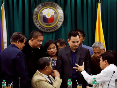 Philippine legislators huddle before voting on the sufficiency of the impeachment complaint against Supreme Court Chief Justice Maria Lourdes Sereno during the House Justice Committe hearing at the House of Representatives in Batasan, Quezon City, metro Manila, Philippines, March 8, 2018. REUTERS/Dondi Tawatao