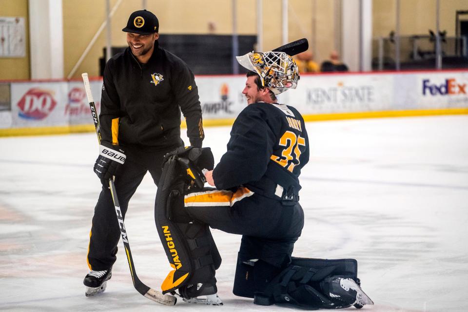 Pittsburgh Penguins hockey operations advisor Trevor Daley, left, talks with goaltender Tristan Jarry during an NHL hockey practice Thursday, Sept. 23, 2021, in Cranberry Township, Pa. (Andrew Rush/Pittsburgh Post-Gazette via AP)