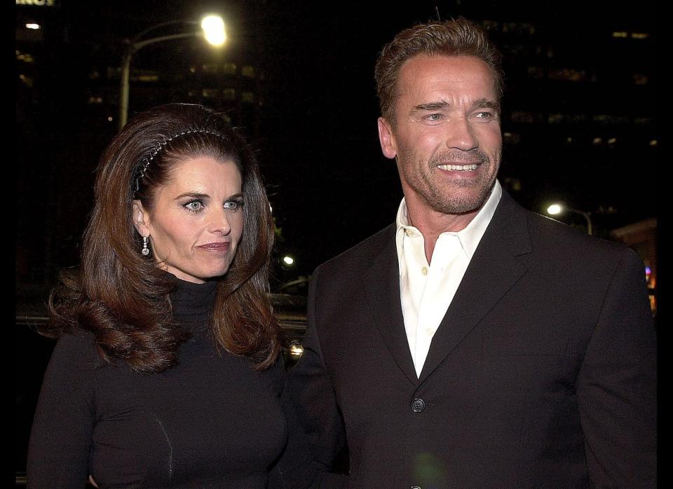 Austrian-born US actor Arnold Schwarzenegger arrives at the premiere of his new film 'The 6th Day' with his wife Maria Shriver in Los Angeles, 13 November 2000. (LUCY NICHOLSON/AFP/Getty Images/November 13, 2000) 