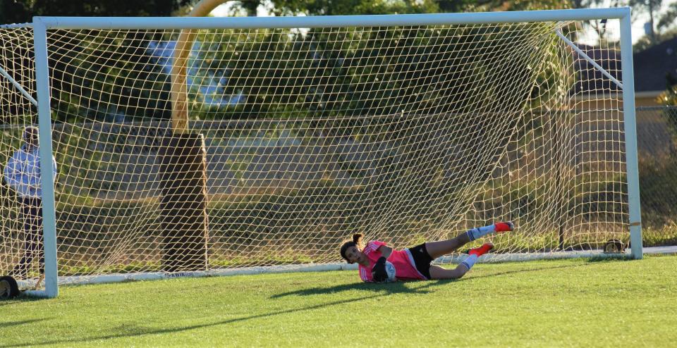 Treasure Coast keeper Kayleigh Marreel makes a diving save during a high school soccer match against Centennial in Port St. Lucie on Tuesday, Jan. 18, 2022. The Titans won the match 3-1.