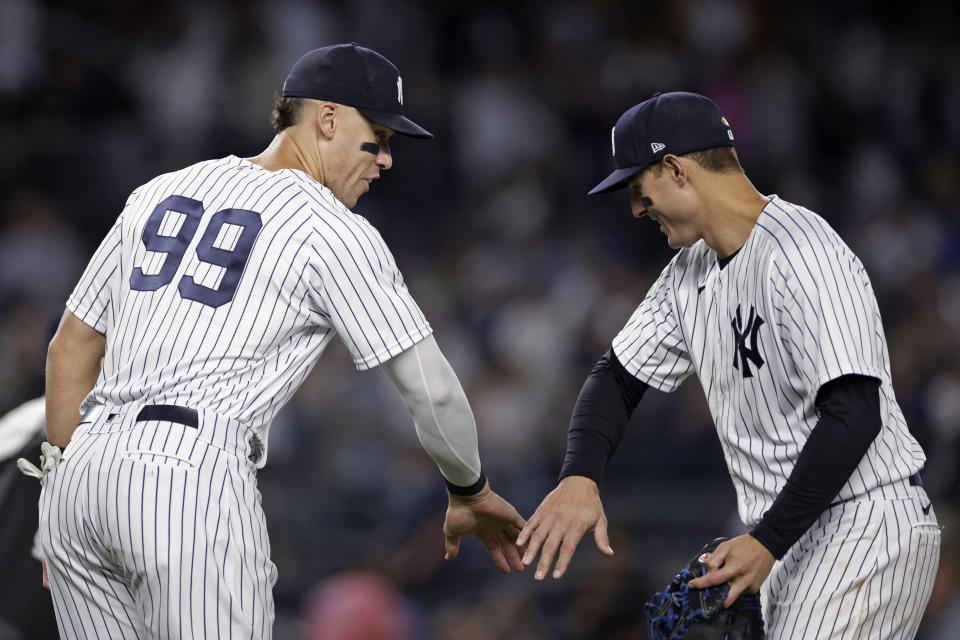 New York Yankees' Aaron Judge (99) celebrates with first baseman Anthony Rizzo after the Yankees defeated the Chicago Cubs 8-0 in a baseball game Saturday, June 11, 2022, in New York. (AP Photo/Adam Hunger)