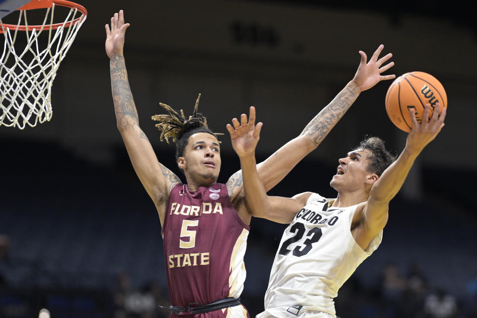 Colorado forward Tristan da Silva (23) goes up for a shot as Florida State forward De'Ante Green (5) defends during the first half of an NCAA college basketball game, Tuesday, Nov. 21, 2023, in Daytona Beach, Fla. (AP Photo/Phelan M. Ebenhack)