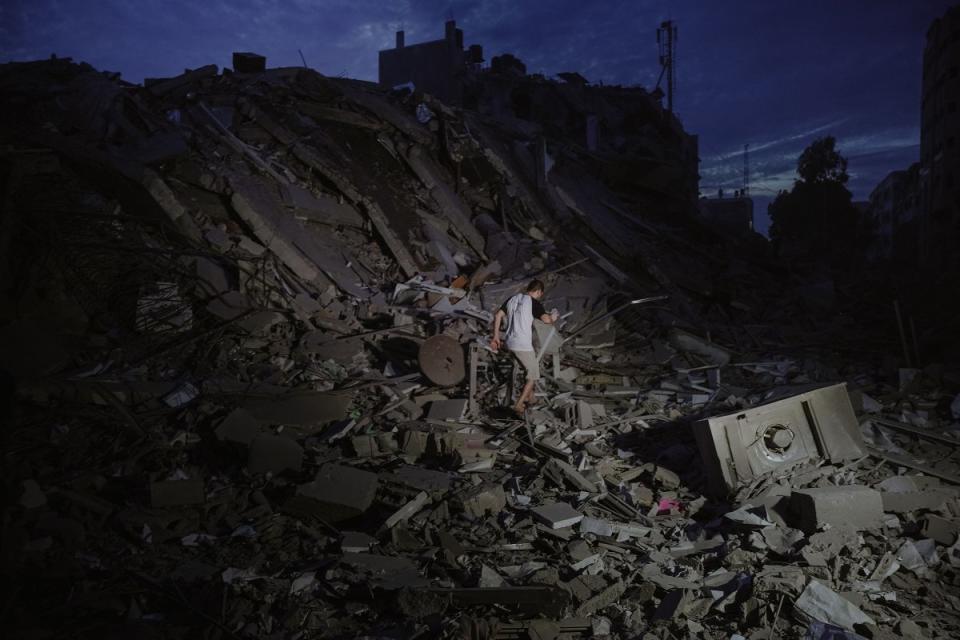 A man walks amid the ruins of a building in Gaza City that was hit by an airstrike on Oct. 7.<span class="copyright">Saher Alghorra—Middle East Images/AFP/Getty Images</span>