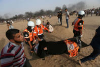 A female demonstrator is evacuated after inhaling tear gas fired by Israeli troops during a protest where Palestinians demand the right to return to their homeland, at the Israel-Gaza border in the southern Gaza Strip May 25, 2018. REUTERS/Ibraheem Abu Mustafa