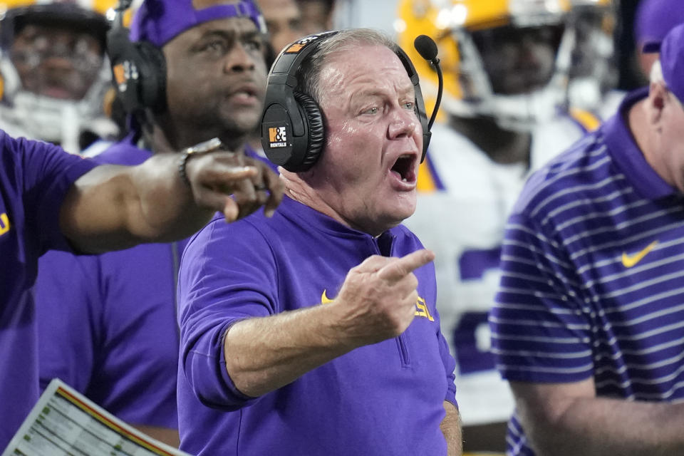 LSU head coach Brian Kelly shouts to players on the field during the first half of an NCAA college football game, Sunday, Sept. 3, 2023, in Orlando, Fla. (AP Photo/John Raoux)