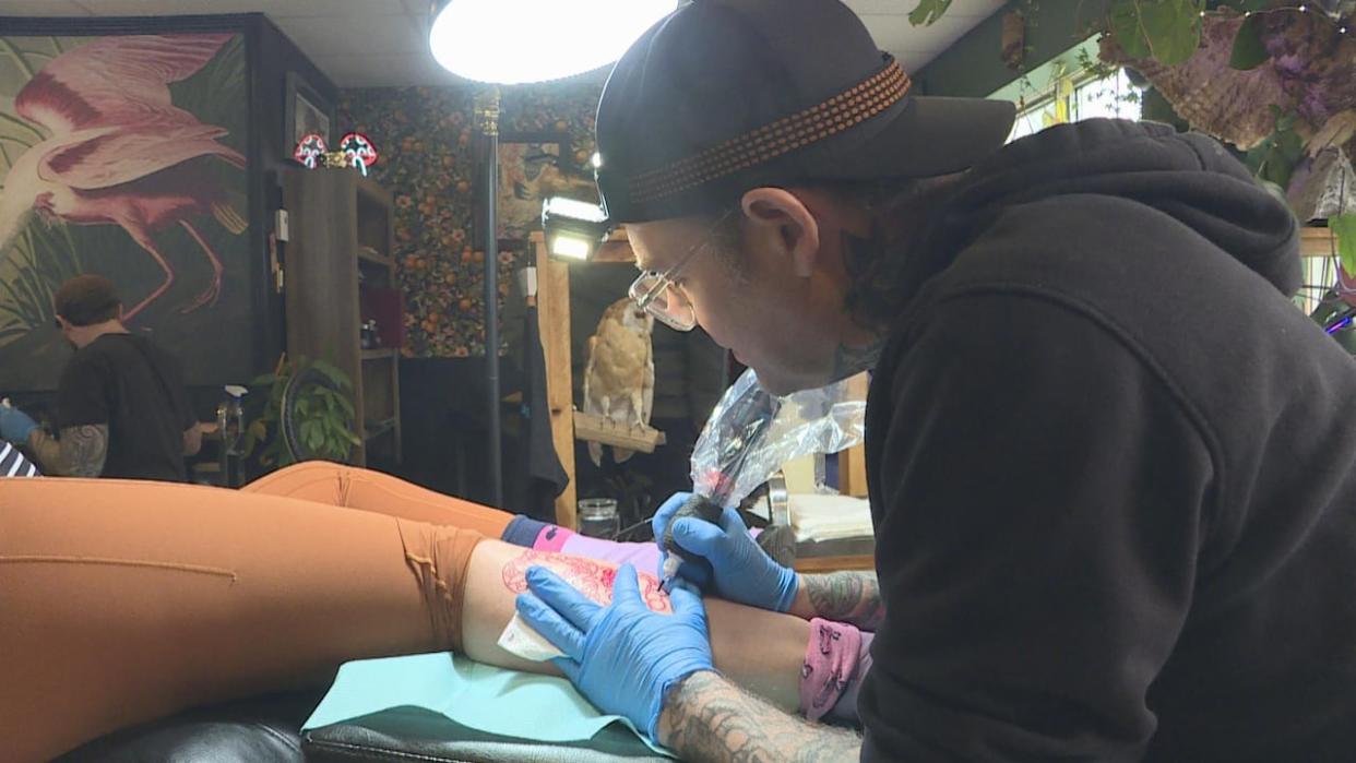 Tattoo artist Shawn Martinson said the goal of the flash event was to help people commemorate Monday's eclipse. (Lars Schwarz/CBC News - image credit)