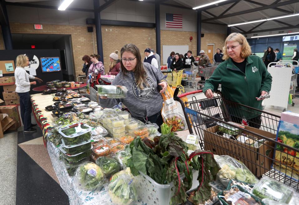 Nicole Martin (left) of Livonia and her mother Ellen Rosenbarker of Honeoye, shop at Sent By Ravens Food Pantry in Livonia.  They said they are thrilled with the quality and variety of goods available at the food pantry. 