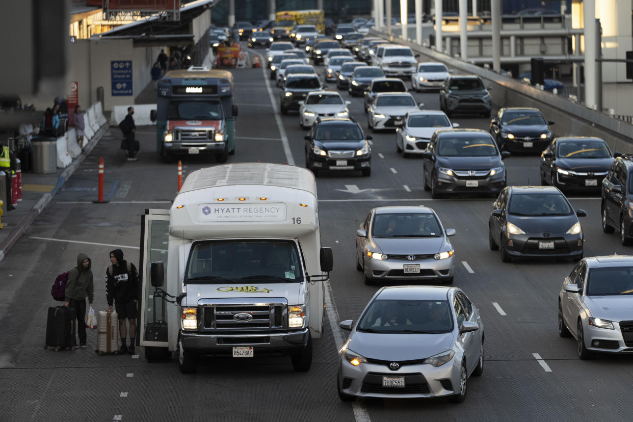 Travelers are dropped off at the Los Angeles International Airport in Los Angeles, Monday, Dec. 19, 2022. Forecasters are warning of treacherous holiday travel and life-threatening cold for big parts of the nation. (AP Photo/Jae C. Hong)