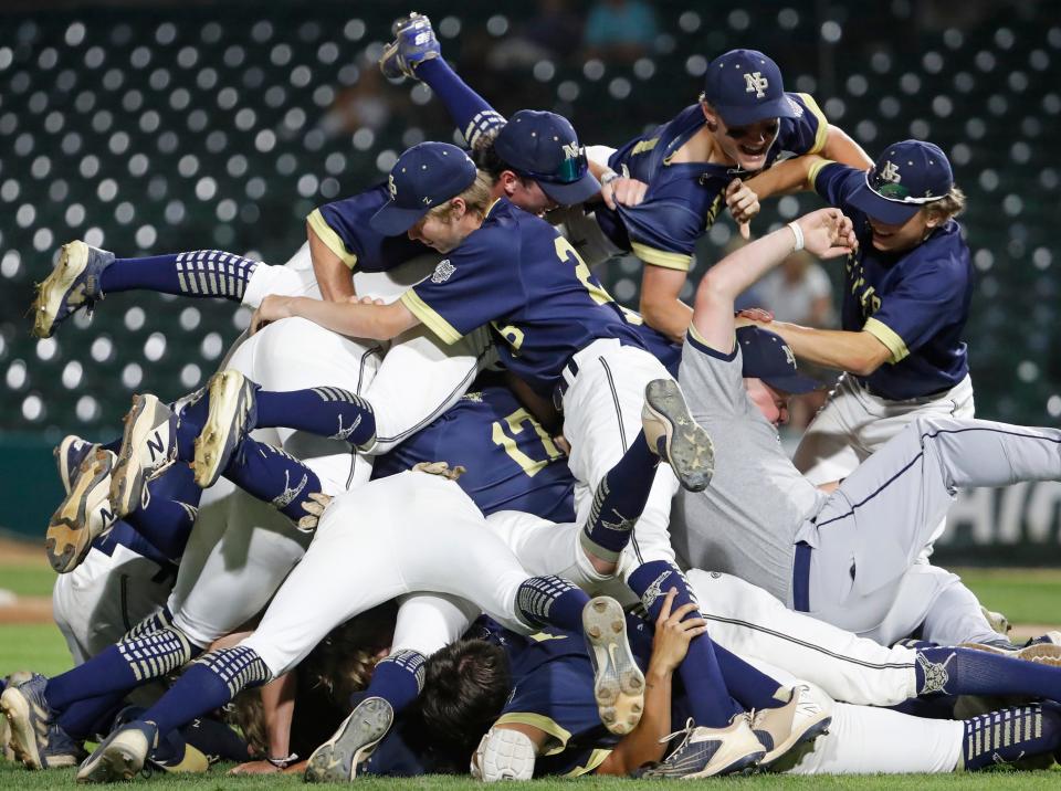 New Prairie Cougars celebrate the IHSAA class 3A baseball state championship game against the Brebeuf Jesuit Braves, Friday, June 14, 2024, at Victory Field in Indianapolis. New Prairie Cougars won 7-2.